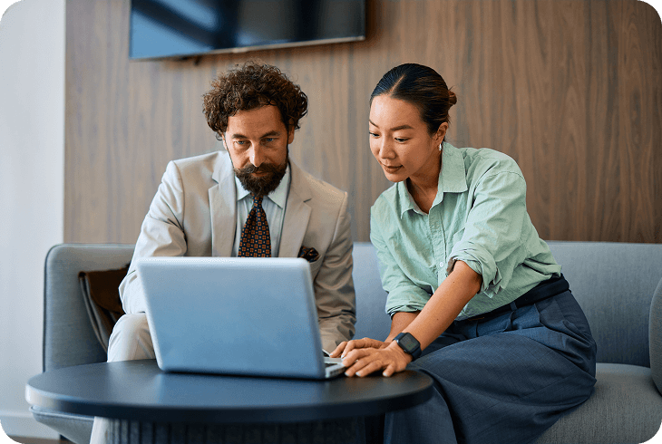 Professionals reviewing information together on laptop